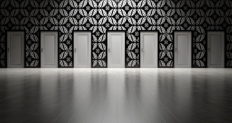 Five closed doors in a black and white ornate hallway symbolizing opportunities and decisions.